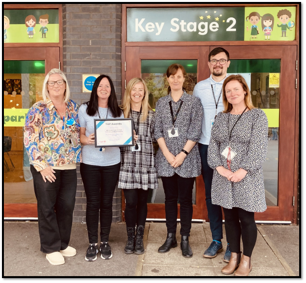 A photo of Mrs Buckley and other St Peter’s C.E. Primary School's staff receiving the TAP Award in Education