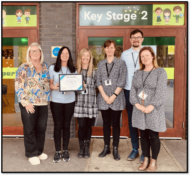 A photo of Mrs Buckley and other St Peter’s C.E. Primary School's staff receiving the TAP Award in Education