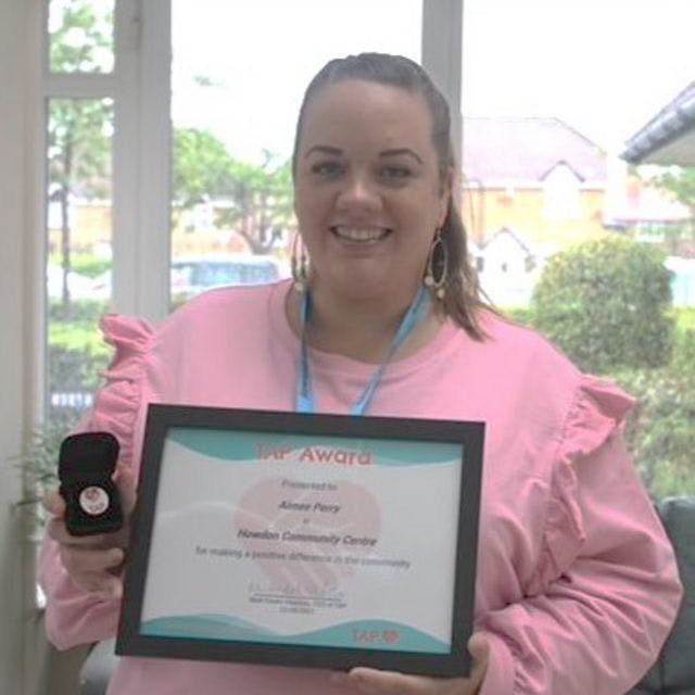 A photo of Aimee Perry of Howdon community centre receiving the TAP Award in Social Care